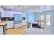 Spacious kitchen with white cabinets, granite countertops, stainless steel appliances, and wood-look floors at 7728 Whispering River St, Las Vegas, NV 89131