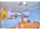 Open kitchen featuring granite countertops, white cabinets, stainless steel appliances, and a breakfast bar at 7728 Whispering River St, Las Vegas, NV 89131