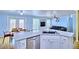 Modern kitchen featuring granite countertops, stainless steel appliances, and an open design that flows into the living area at 7728 Whispering River St, Las Vegas, NV 89131
