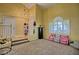 Inviting living room featuring a staircase, high ceilings, neutral carpeting, and a wall-mounted television at 7728 Whispering River St, Las Vegas, NV 89131