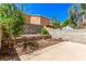 Wide shot of desert backyard, concrete patio, block wall, metal stairs, and desert landscaping at 8041 Astrology Ct # 201, Las Vegas, NV 89128