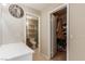 Neutral bathroom with tile floor, white cabinets, and an adjoining walk-in closet at 8041 Astrology Ct # 201, Las Vegas, NV 89128