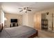 Spacious bedroom featuring a ceiling fan, TV, and closet at 8041 Astrology Ct # 201, Las Vegas, NV 89128