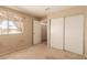 Carpeted bedroom features a window, closet, and neutral wall color scheme at 8041 Astrology Ct # 201, Las Vegas, NV 89128