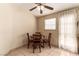 Charming dining area featuring a wooden table with four chairs and ample natural light at 8041 Astrology Ct # 201, Las Vegas, NV 89128