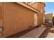 This is the exterior of the house with a side entrance and a walkway of concrete and rock at 8041 Astrology Ct # 201, Las Vegas, NV 89128