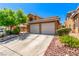 Two-story house showcasing a spacious driveway, a two-car garage and low maintenance landscaping at 8041 Astrology Ct # 201, Las Vegas, NV 89128