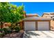 Charming home featuring a two-car garage, well-maintained landscaping, and a classic tile roof at 8041 Astrology Ct # 201, Las Vegas, NV 89128
