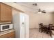 Kitchen with white refrigerator and microwave next to a dining space at 8041 Astrology Ct # 201, Las Vegas, NV 89128