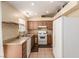 Bright kitchen with range, stainless steel sink, and refrigerator at 8041 Astrology Ct # 201, Las Vegas, NV 89128