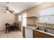 Kitchen featuring a dining area, stainless steel sink, and plenty of natural light at 8041 Astrology Ct # 201, Las Vegas, NV 89128