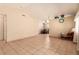 Open living space with tile flooring extending to a dining area in a neutral color palette at 8041 Astrology Ct # 201, Las Vegas, NV 89128