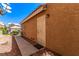 Side entrance to the home with metal security door and a walkway of concrete and rock at 8041 Astrology Ct # 201, Las Vegas, NV 89128