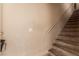 Carpeted staircase features a painted handrail ascending to the upper levels of the home at 8041 Astrology Ct # 201, Las Vegas, NV 89128