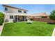 Backyard with artificial turf, covered patio, and privacy fence at 8061 Palace Estate Ave, Las Vegas, NV 89117