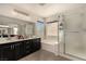 Elegant bathroom with double vanities, soaking tub, glass-enclosed shower, and modern fixtures at 8061 Palace Estate Ave, Las Vegas, NV 89117
