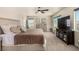 This spacious bedroom has plenty of natural light, large windows, ceiling fan and plush carpet at 8061 Palace Estate Ave, Las Vegas, NV 89117