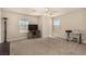 Bright bedroom with a ceiling fan, plush carpet and two large windows at 8061 Palace Estate Ave, Las Vegas, NV 89117