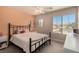 Cozy bedroom featuring a wrought iron bed frame, plush carpet, and ample natural light at 8061 Palace Estate Ave, Las Vegas, NV 89117