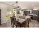 Open dining area leading to the backyard, showcasing stylish lighting and modern decor at 8061 Palace Estate Ave, Las Vegas, NV 89117