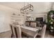 Spacious dining area with modern light fixtures and an open layout to the living room at 8061 Palace Estate Ave, Las Vegas, NV 89117