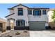 Inviting two-story home featuring a neutral color palette, rock garden, and an attached two-car garage at 8061 Palace Estate Ave, Las Vegas, NV 89117