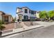 Attractive two-story home showcasing a well-maintained yard, rock garden and attached two-car garage at 8061 Palace Estate Ave, Las Vegas, NV 89117