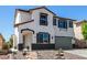 Charming two-story home featuring a cozy porch, an attractive rock garden, and a two-car garage at 8061 Palace Estate Ave, Las Vegas, NV 89117