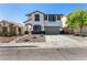 Charming two-story home with a landscaped front yard and a two-car garage in a suburban neighborhood at 8061 Palace Estate Ave, Las Vegas, NV 89117