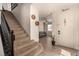 Bright entryway features a staircase, stylish decor, and an open view into the living room at 8061 Palace Estate Ave, Las Vegas, NV 89117