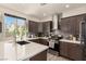 Modern kitchen featuring stainless steel appliances, gray backsplash and light countertops at 8061 Palace Estate Ave, Las Vegas, NV 89117