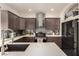 Spacious kitchen with stainless steel appliances, shaker cabinets, gray backsplash, and light countertops at 8061 Palace Estate Ave, Las Vegas, NV 89117