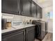 Laundry room featuring a white countertop and stainless steel washer and dryer at 8061 Palace Estate Ave, Las Vegas, NV 89117