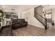 Inviting living room with luxury vinyl plank flooring and access to kitchen and stairs at 8061 Palace Estate Ave, Las Vegas, NV 89117