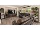 Comfortable living room featuring wood-look floors, ample seating, and an entertainment center at 8061 Palace Estate Ave, Las Vegas, NV 89117