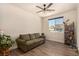 Comfortable living room featuring a ceiling fan, neutral paint, hardwood floors and bright, natural light at 8061 Palace Estate Ave, Las Vegas, NV 89117