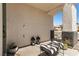 Comfortable covered porch with striped bench and decorative lanterns, offering a relaxing outdoor space at 8061 Palace Estate Ave, Las Vegas, NV 89117