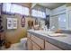 Bright bathroom featuring a neutral color palette, a vanity with a light-colored countertop, and charming decorative touches at 816 Sandsprings St, Henderson, NV 89011