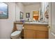 Compact powder room featuring toilet, sink, vanity, mirror and decor at 816 Sandsprings St, Henderson, NV 89011