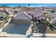 Inviting exterior elevation features a well-manicured yard and a spacious three-car garage at 816 Sandsprings St, Henderson, NV 89011