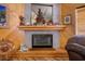 Close-up of a fireplace with tiled surround, mantel decorations, and adjacent seating at 816 Sandsprings St, Henderson, NV 89011