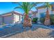 Close-up view of the front yard featuring desert landscaping with mature palm trees at 816 Sandsprings St, Henderson, NV 89011