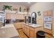Functional kitchen featuring an island cooktop, stainless steel appliances, and wood-look floors at 816 Sandsprings St, Henderson, NV 89011