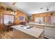 Bright kitchen featuring a cooktop island, wooden walls, and a cozy breakfast nook at 816 Sandsprings St, Henderson, NV 89011