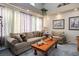Spacious living room with neutral tones, a large sofa, and a decorative coffee table at 816 Sandsprings St, Henderson, NV 89011