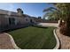Back yard featuring artificial grass, palm tree, and patio at 851 Brahma Ln, Henderson, NV 89002