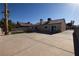 Expansive backyard showcasing a large concrete patio, low-maintenance turf, and mature palm trees, perfect for outdoor living at 851 Brahma Ln, Henderson, NV 89002