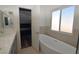 Bathroom featuring double vanity and standalone soaking tub with natural light at 851 Brahma Ln, Henderson, NV 89002