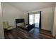 A light filled bedroom with wood floors and a sliding glass door at 851 Brahma Ln, Henderson, NV 89002