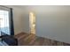 A bright empty bedroom with wood floors and access to the bath and back yard at 851 Brahma Ln, Henderson, NV 89002